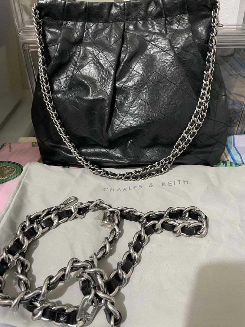 Charles and Keith Double Chain Hobo Bag (Category: Shoulder Bags) located in Cavite. Submitted by lysagaoinit (Listing ID 1466567485, Image 1). Description: -Charles and Keith Double Chain Hobo Bag -Black -Heavily signes of used but still not visible at far -Dust Bag and Extra Chain -Bought from Charles and Keith Greenbelt 1 -Brand New Price 5,999 -Payment via Gcash/Maya/Bank -Delivery via Lalamove (to be shouldered by customer) or J&T (free deli
