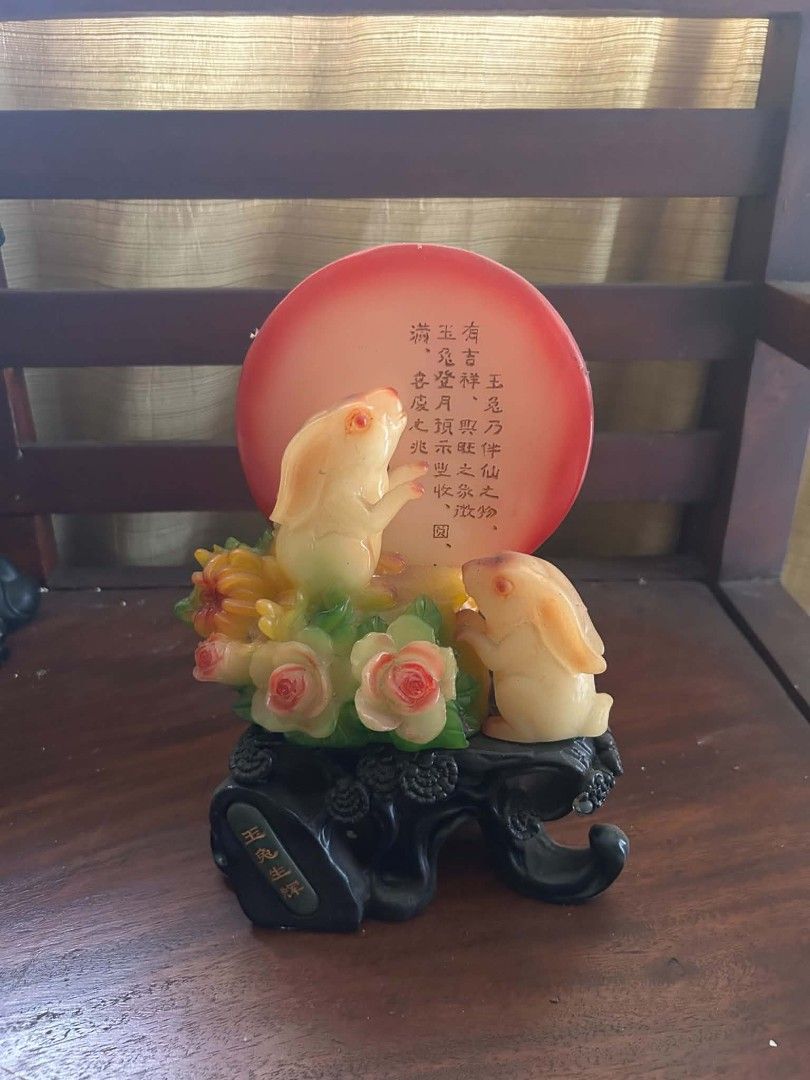 Chinese Jade Rabbit Figurine With Red Moon Backdrop (Category: Vintage Collectibles) located in Makati City. Submitted by YSL80022 (Listing ID 1466623204, Image 1). Description: - Elegant Chinese jade rabbit figurine resting on floral details - Features a striking red circular backdrop with traditional Chinese calligraphy - Mounted on a carved black decorative base with gold lettering on the front - Crafted from a heavy, premium resin or stone ma