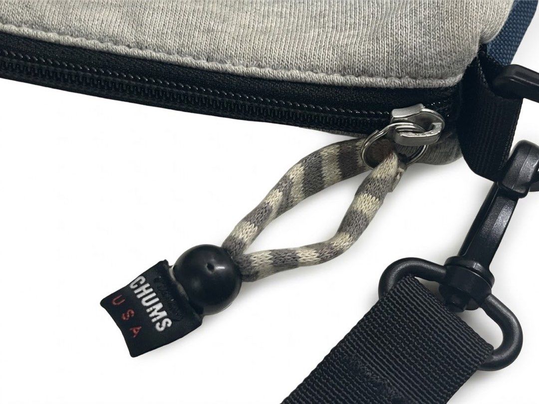 Chums Sweat & Nylon Sling Bag - Heather Gray (Category: Sling Bags) located in Manila. Submitted by djmac12271982 (Listing ID 1466711931, Image 2). Description: Design & Storage: Features a main zippered compartment with a black lining, an interior care/tag pocket, and a front pocket with velcro closure for quick-access essentials. Straps & Hardware: Adjustable black webbing cross-body strap with sturdy clip attachments and heavy-duty zippers. Co