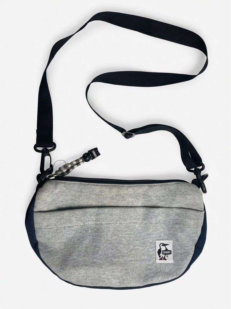 Chums Sweat & Nylon Sling Bag - Heather Gray (Category: Sling Bags) located in Manila. Submitted by djmac12271982 (Listing ID 1466711931, Image 1). Description: Design & Storage: Features a main zippered compartment with a black lining, an interior care/tag pocket, and a front pocket with velcro closure for quick-access essentials. Straps & Hardware: Adjustable black webbing cross-body strap with sturdy clip attachments and heavy-duty zippers. Co