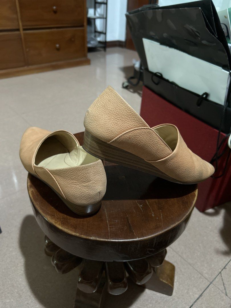 Clarks Cushion Soft Nude Wedge Flats (Category: Flats & Sandals) located in Alitagtag. Submitted by patrickvillanueva (Listing ID 1466615163, Image 3). Description: - Brand: Clarks - Style: Nude leather slip-on shoes with pointed toes and low wedge heels - Comfort: Cushion Soft insoles for all-day wearability - Material: Textured pebble leather upper in neutral beige - Condition: Worn a few times with minor scuffs on the toe area.