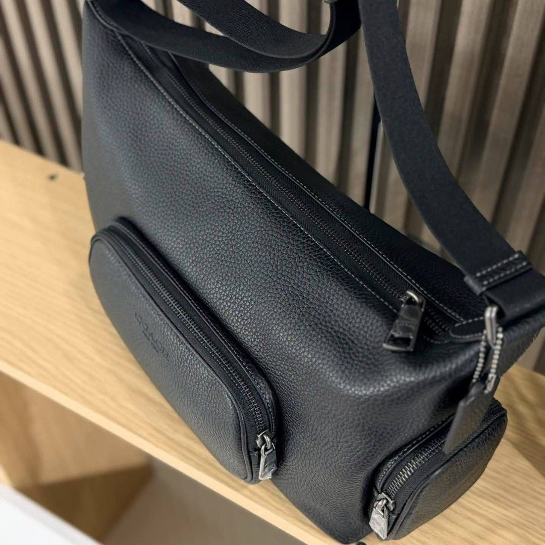 Coach Black Leather Crossbody Bag with Multiple Pockets (Category: Cross-body Bags) located in Manila. Submitted by rhona30antiquera (Listing ID 1466611159, Image 3). Description: - 100% Authentic Coach crossbody bag - Color/Material: Black pebbled leather with gunmetal hardware - Storage: 1 main top zip compartment and 3 exterior zip pockets (front and sides) - Strap: Adjustable black shoulder strap - Condition: Brand new with original store tag