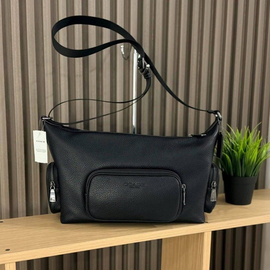Coach Black Leather Crossbody Bag with Multiple Pockets (Category: Cross-body Bags) located in Manila. Submitted by rhona30antiquera (Listing ID 1466611159, Image 1). Description: - 100% Authentic Coach crossbody bag - Color/Material: Black pebbled leather with gunmetal hardware - Storage: 1 main top zip compartment and 3 exterior zip pockets (front and sides) - Strap: Adjustable black shoulder strap - Condition: Brand new with original store tag