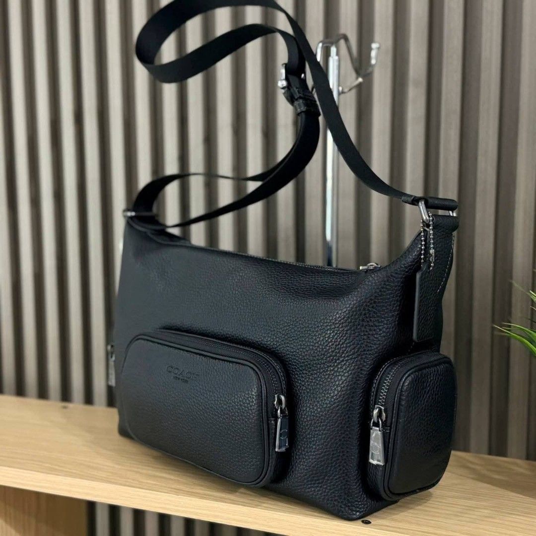 Coach Black Leather Crossbody Bag with Multiple Pockets (Category: Cross-body Bags) located in Manila. Submitted by rhona30antiquera (Listing ID 1466611159, Image 2). Description: - 100% Authentic Coach crossbody bag - Color/Material: Black pebbled leather with gunmetal hardware - Storage: 1 main top zip compartment and 3 exterior zip pockets (front and sides) - Strap: Adjustable black shoulder strap - Condition: Brand new with original store tag