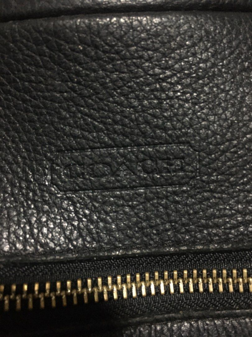 Coach Black Leather Shoulder Bag (Category: Luxury Bags & Wallets) located in Manila. Submitted by findingtreasure. (Listing ID 1466718820, Image 2). Description: Coach black pebble leather shoulder bag. Includes top handles plus an adjustable and removable strap. Exterior features a zip pocket with a decorative signature medallion charm. Zip-top closure opens to a vibrant purple satin lining with an interior creed patch stamped F17566. Silver-to