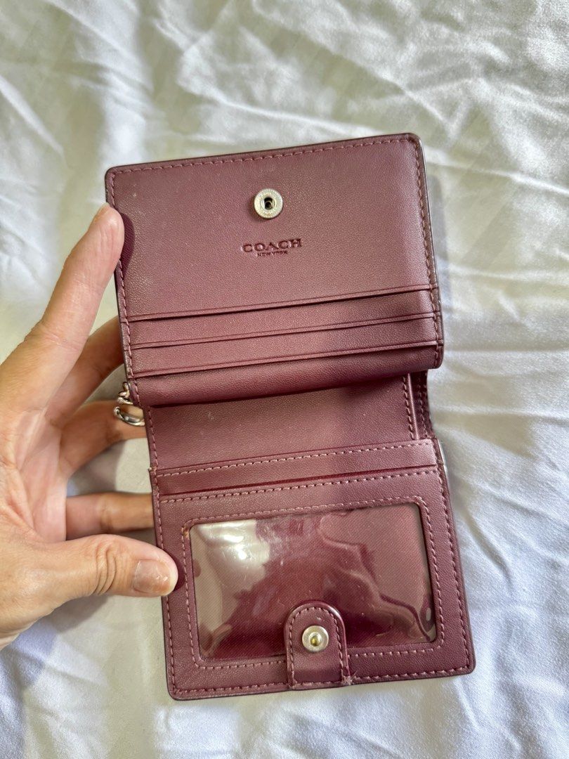 Coach Leather Medium Wallet Pink Burgundy (Category: Luxury Bags & Wallets) located in Pasig City. Submitted by marizanne04 (Listing ID 1466727151, Image 2). Description: - Brand: Coach - Material: Premium pink pebbled leather with burgundy interior lining - Closure: Secure front snap closure - Compartments: Multiple card slots, clear ID window, and spacious cash compartment - Coin Pocket: Convenient side pocket with zipper closure - Hardware: Go