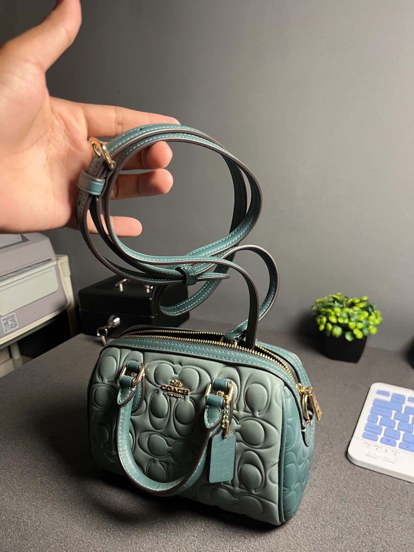 Coach mini rowan (Category: Luxury Bags & Wallets) located in Leyte. Submitted by riley.b95 (Listing ID 1466628733, Image 1). Description: 💚 AUTHENTIC COACH MINI ROWAN PRELOVED, USED ONCE 💚 ✨ Condition: Like New / Used Once Only ✨ Authentic Coach ✨ Beautiful embossed Signature design ✨ Gorgeous sage/green color ✨ Gold-tone hardware ✨ Top handles + detachable shoulder/crossbody strap ✨ Zip-top closure ✨ No issues / no visible flaws ✨ Very well c