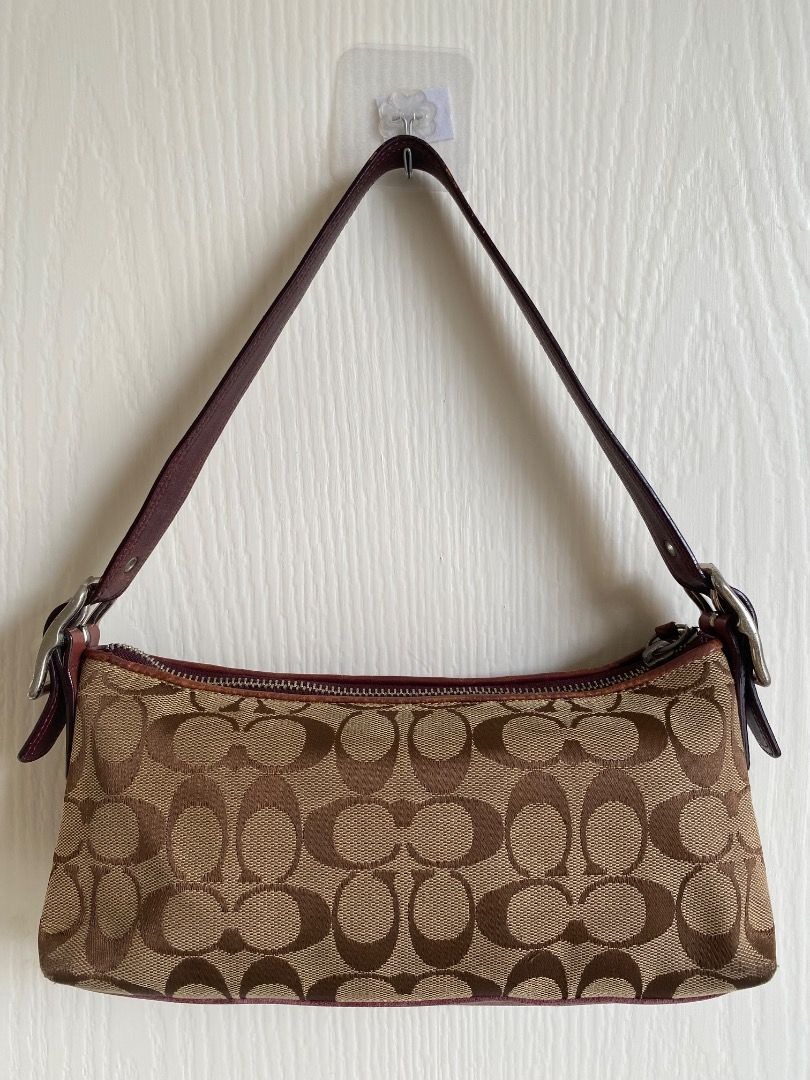 Coach Signature C Suede Stripe Shoulder (Category: Shoulder Bags) located in Caloocan City. Submitted by elisza.77wzd (Listing ID 1466746714, Image 2). Description: Authentic Coach Y2K shoulder bag featuring signature C canvas, pink and brown suede panels, and brown leather strap with a tassel accent. Zip top closure with silver hardware. Stylish and compact for everyday use. Message for inquiries!.