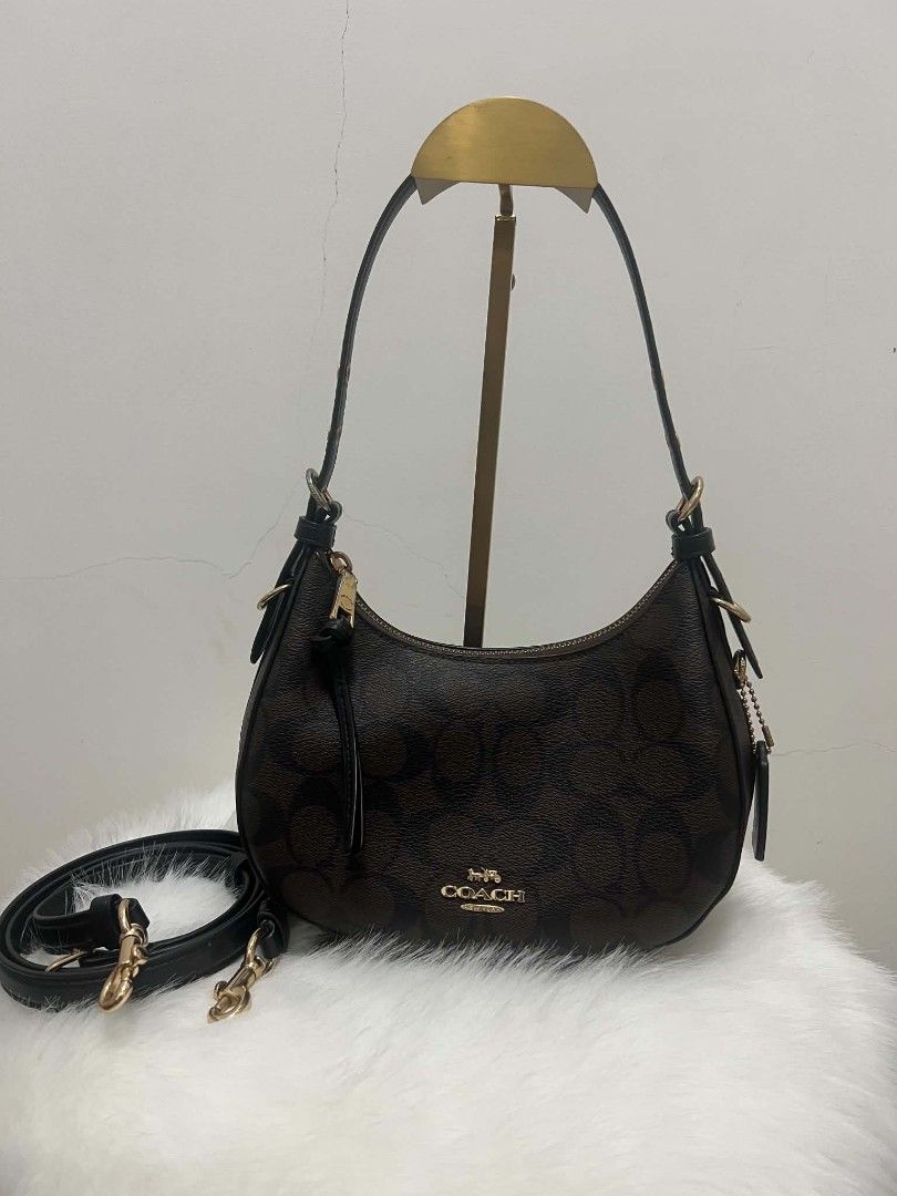 Coach Signature Monogram Shoulder Bag (Category: Shoulder Bags) located in Paoay. Submitted by rvf1230 (Listing ID 1466578775, Image 1). Description: - Authentic Coach shoulder bag in signature brown monogram print with black leather trim - Elegant gold-tone hardware and matching black leather hangtag on a beaded chain - Secure top zipper closure with a convenient leather pull strap - Dark fabric-lined interior complete with a handy slip pocket -