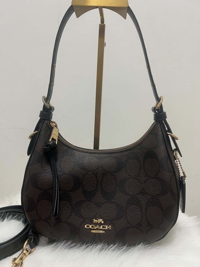 Coach Signature Monogram Shoulder Bag (Category: Shoulder Bags) located in Paoay. Submitted by rvf1230 (Listing ID 1466578775, Image 2). Description: - Authentic Coach shoulder bag in signature brown monogram print with black leather trim - Elegant gold-tone hardware and matching black leather hangtag on a beaded chain - Secure top zipper closure with a convenient leather pull strap - Dark fabric-lined interior complete with a handy slip pocket -