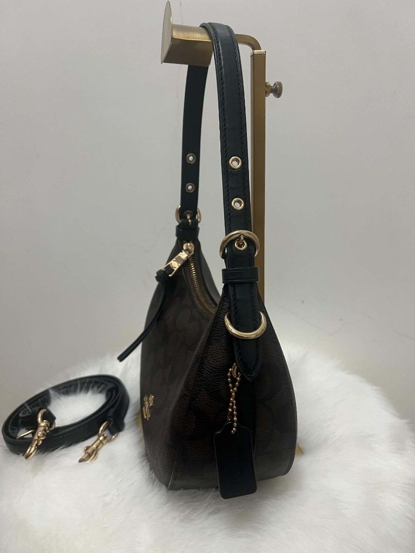 Coach Signature Monogram Shoulder Bag (Category: Shoulder Bags) located in Paoay. Submitted by rvf1230 (Listing ID 1466578775, Image 3). Description: - Authentic Coach shoulder bag in signature brown monogram print with black leather trim - Elegant gold-tone hardware and matching black leather hangtag on a beaded chain - Secure top zipper closure with a convenient leather pull strap - Dark fabric-lined interior complete with a handy slip pocket -
