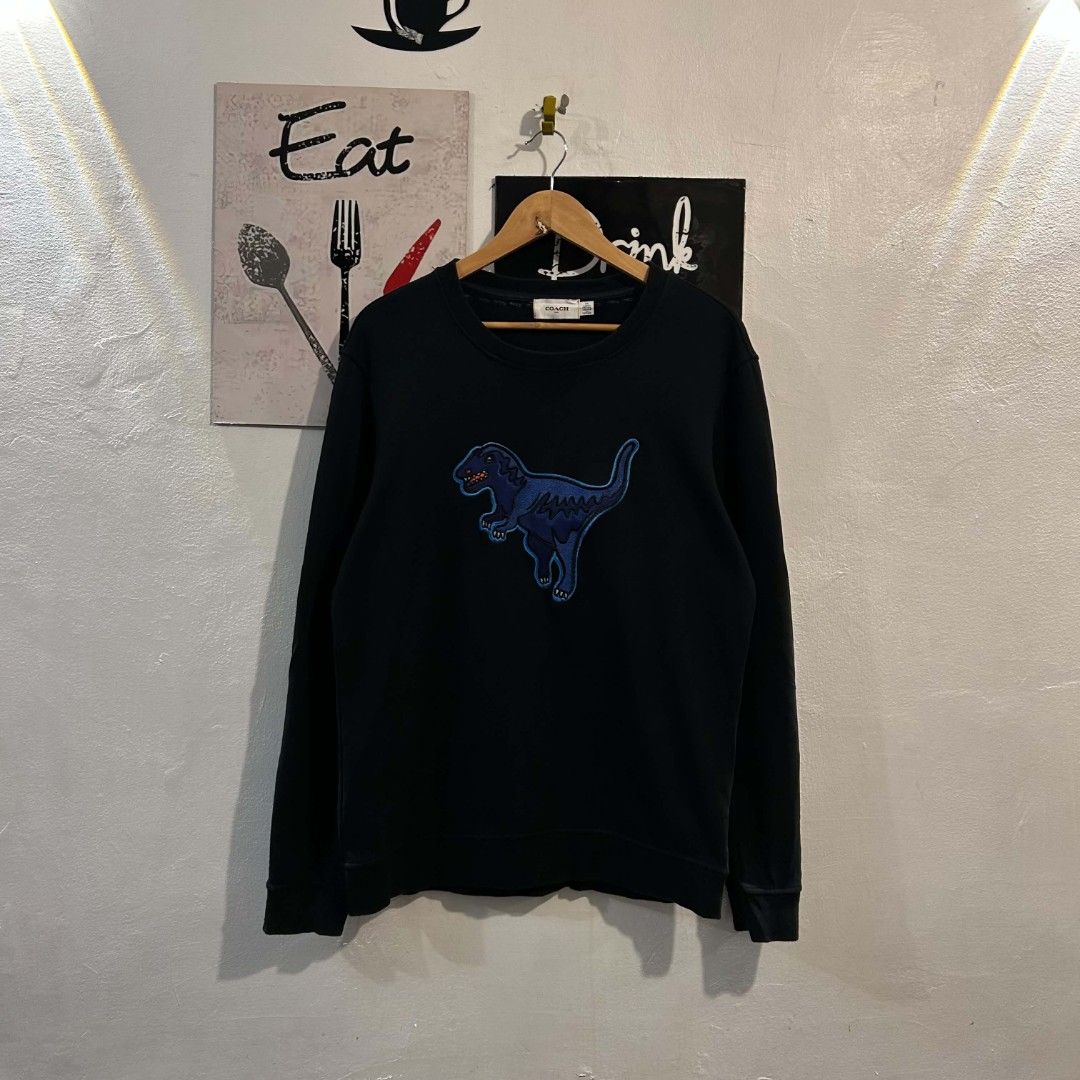 Coach Sweatshirt Blue Embroidered Rexy Dinosaur Pullover (Category: Coats, Jackets and Outerwear) located in Quezon City. Submitted by streetwearandluxph (Listing ID 1466563945, Image 1). Description: Coach Sweatshirt Blue Embroidered Rexy Dinosaur Pullover.