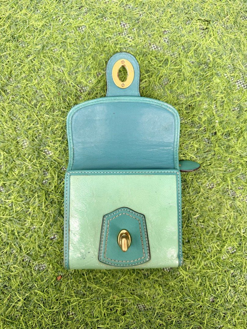 Coach Teal Legacy Wallet (Category: Purses & Pouches) located in Quezon City. Submitted by p0tatooooooo (Listing ID 1466584420, Image 3). Description: A gorgeous vintage Coach Legacy wallet in a beautiful teal/turquoise shade, featuring classic Coach detailing and antique gold-tone hardware. The structured design and iconic turn-lock closure give it that timeless vintage Coach charm. ✨ Pre-loved vintage condition with visible signs of age/use, ad