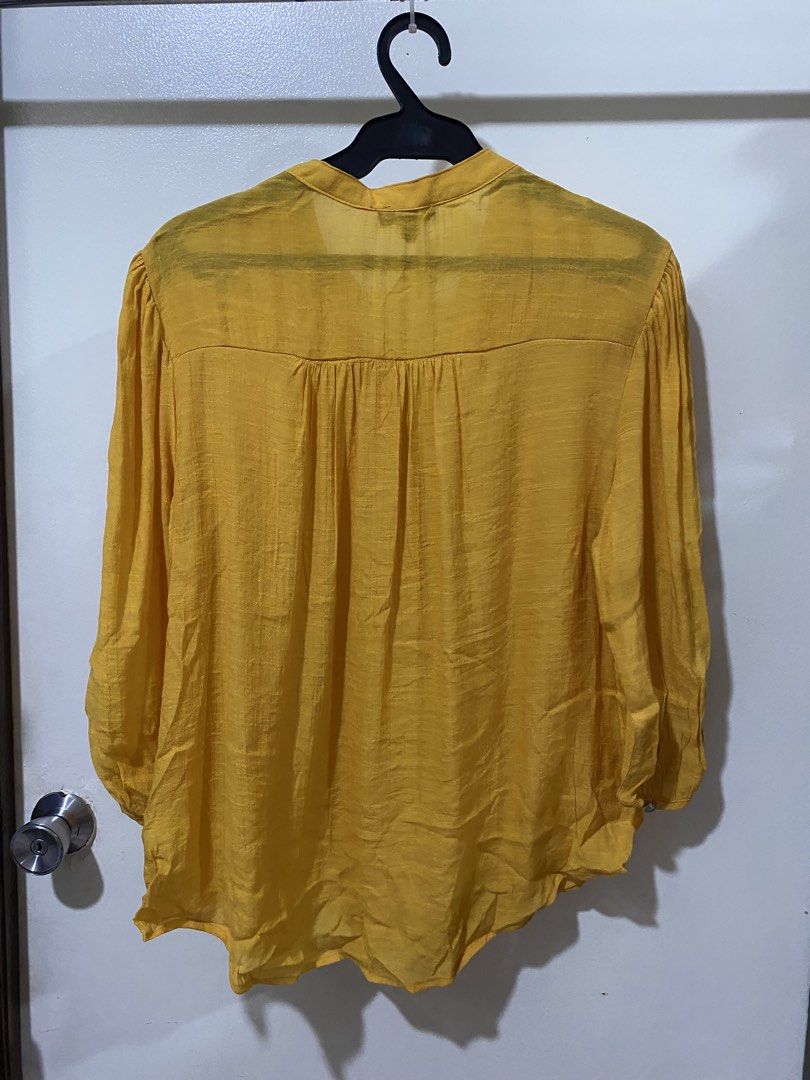 Cocomo Petite Yellow Button-Down Blouse PXL (Category: Blouses) located in Manila. Submitted by divinemercy_29 (Listing ID 1466634268, Image 2). Description: - Brand: Cocomo Petite - Size: PXL - Color: Bright Yellow - Material: Lightweight textured fabric - Origin: Made in Cambodia - Details: 4-button neckline placket, front pleats, back yoke gathers, and long sleeves with gathered cuffs - Fit: Flowy and comfortable - Never worn however no more t