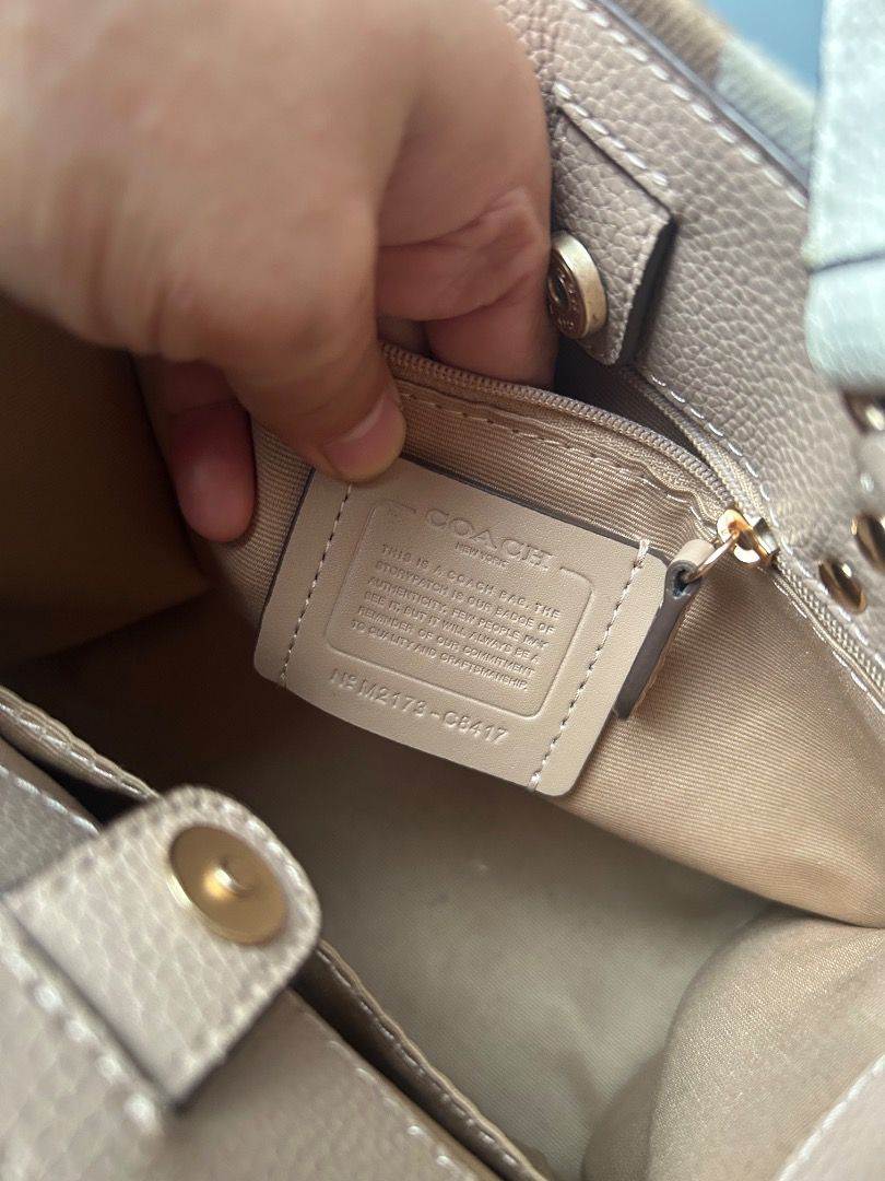 co**h (Category: Tote Bags) located in Caloocan City. Submitted by maryjane.r (Listing ID 1466568627, Image 3). Description: ✔️ Model: Dempsey 22 - C2007 / CA195 ✔️ Material: Signature jacquard + pebbled leather trim ✔️ Color: Beige / Chalk / Tan stripe - neutral aesthetic ✔️ Patch: Large Coach circle patch embossed "America's Original EST 1941" ✔️ Hardware: Gold rivets + Coach engraved hook ✔️ Strap: 2-way - top handles + long adjustable sling ✔
