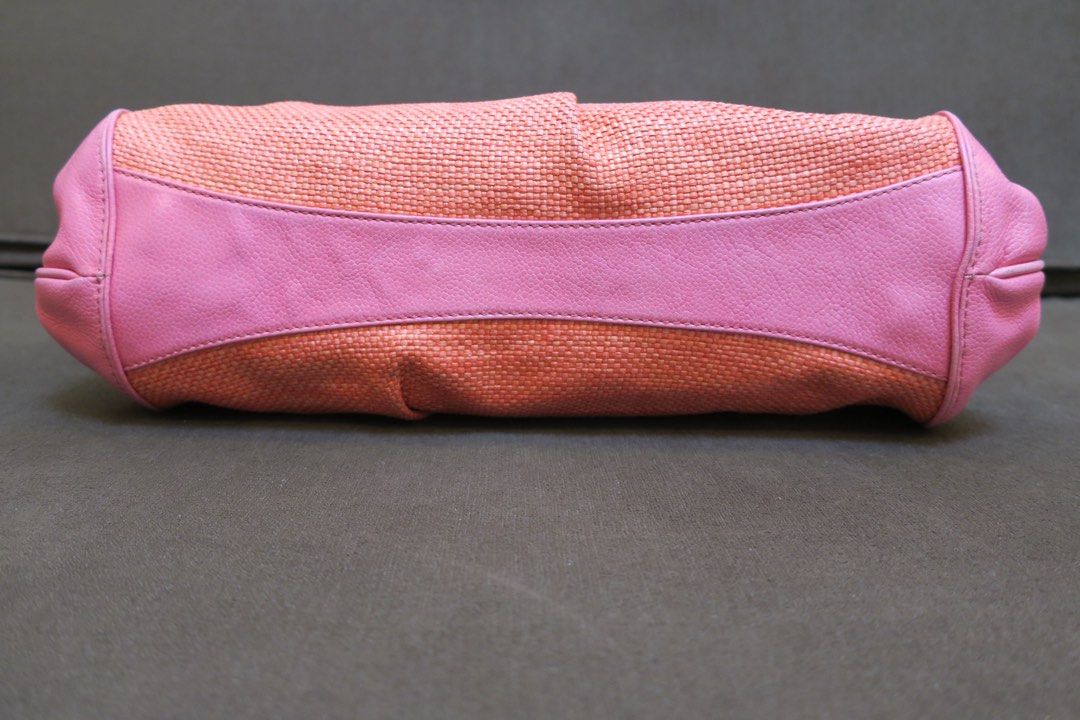 Cole haan pink bag (Category: Shoulder Bags) located in Taguig. Submitted by baghabitmnl (Listing ID 1466614820, Image 3). Description: - Vibrant pink and orange shoulder bag - Lower half made of woven straw with pink leather trim - Double braided pink handles for comfortable carry - Gold metal hardware with front strap clasp closure - Spacious enough for daily essentials - Perfect statement piece for casual days or vacations.