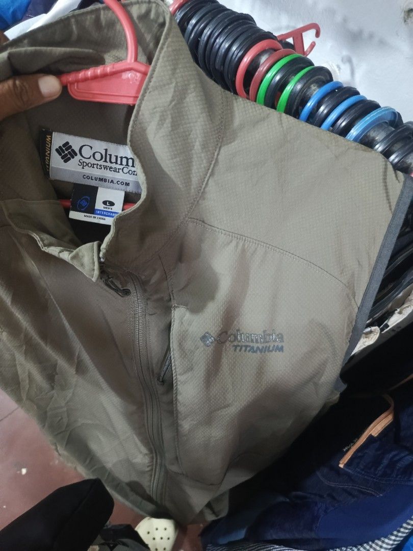 Columbia Titanium Men's Interchange Vest Size L (Category: Vests) located in City of Isabela. Submitted by warmbird.d06e6f (Listing ID 1466670472, Image 3). Description: - Brand: Columbia Titanium - Style: Men's Interchange Line Vest - Color: Olive Green - Size: Men's Large - Material/Build: Lightweight fabric construction - Features: Full zip front, high collar, and secure chest zip pocket - Details: Iconic Columbia logo on the front - Best For: