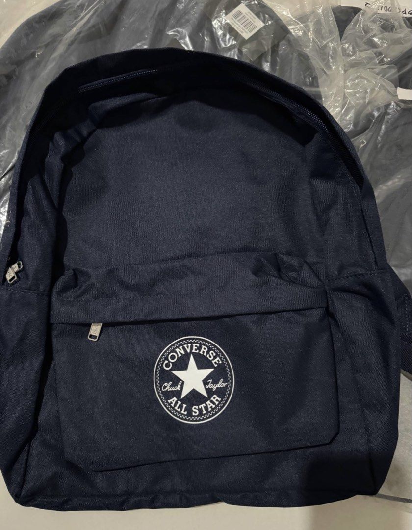 Converse All Star Navy Blue Backpack (Category: Backpacks) located in Angeles City. Submitted by msskyve (Listing ID 1466606613, Image 2). Description: - Brand: Converse - Color: Dark Navy Blue - Material: 100% Polyester - Design: Classic Chuck Taylor All Star patch on front pocket - Compartments: Zip closure main compartment with interior zippered pocket and branded tag - Straps: Adjustable with black plastic adjusters - Condition: Brand new wit