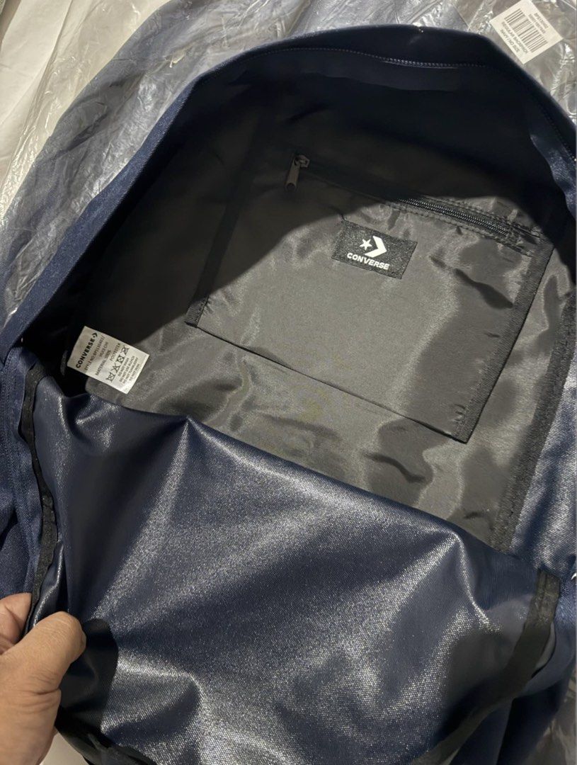 Converse All Star Navy Blue Backpack (Category: Backpacks) located in Angeles City. Submitted by msskyve (Listing ID 1466606613, Image 3). Description: - Brand: Converse - Color: Dark Navy Blue - Material: 100% Polyester - Design: Classic Chuck Taylor All Star patch on front pocket - Compartments: Zip closure main compartment with interior zippered pocket and branded tag - Straps: Adjustable with black plastic adjusters - Condition: Brand new wit