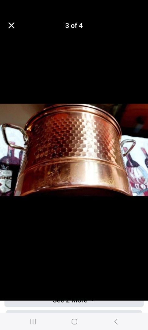 Copper Pot with Glass Lid and Steamer Insert (Category: Cookware & Accessories) located in Cainta. Submitted by veronica2277 (Listing ID 1466690378, Image 3). Description: - Elegant copper pot with dual handles - Includes a clear glass lid and a stainless steel steamer insert with a middle handle - Shiny hammered exterior finish with minor patina and discoloration near the bottom edge - Clean and metallic cooking interior - Great addition to your