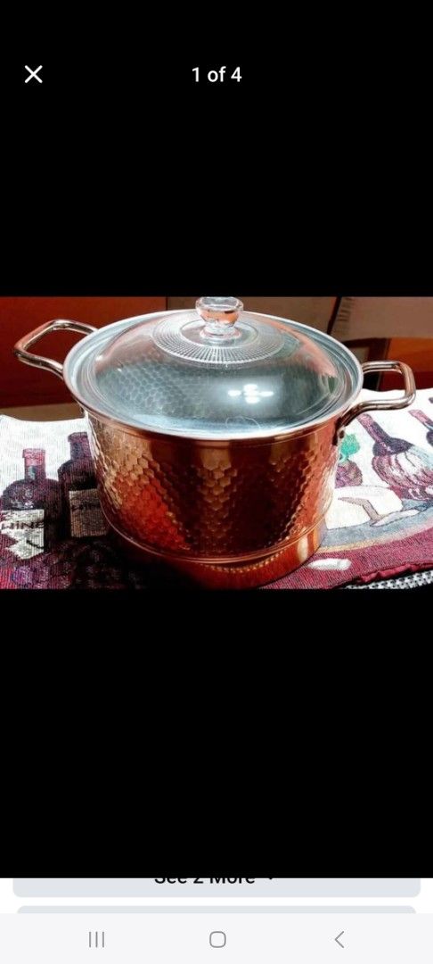 Copper Pot with Glass Lid and Steamer Insert (Category: Cookware & Accessories) located in Cainta. Submitted by veronica2277 (Listing ID 1466690378, Image 1). Description: - Elegant copper pot with dual handles - Includes a clear glass lid and a stainless steel steamer insert with a middle handle - Shiny hammered exterior finish with minor patina and discoloration near the bottom edge - Clean and metallic cooking interior - Great addition to your