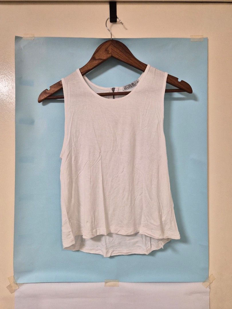 Cotton On White Tank Top Size S (Category: Sleeveless) located in Manila. Submitted by prelovedbyc.hannah (Listing ID 1466712105, Image 1). Description: - Brand: Cotton On - Color: White - Size: Small (S) - Made in China - Unique feature: Zip detail on the back neckline - Lightweight sleeveless design, perfect for warm weather or layering - Condition: Clean, with tags intact inside the collar.