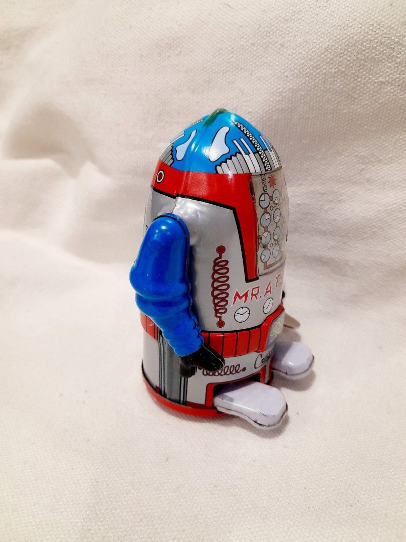 Cragstan Mr. Atomic Tin Toy Robot with Box (Category: Vintage Collectibles) located in Quezon City. Submitted by warmgem.dde5c0 (Listing ID 1466606434, Image 3). Description: - Vintage Cragstan Mr. Atomic wind-up tin toy robot - Classic blue and red design with clockwork chest graphics - Compact size measuring approximately 3.5 inches tall - Fully working wind-up mechanism with attached key - Comes with the original matching graphic box featuring
