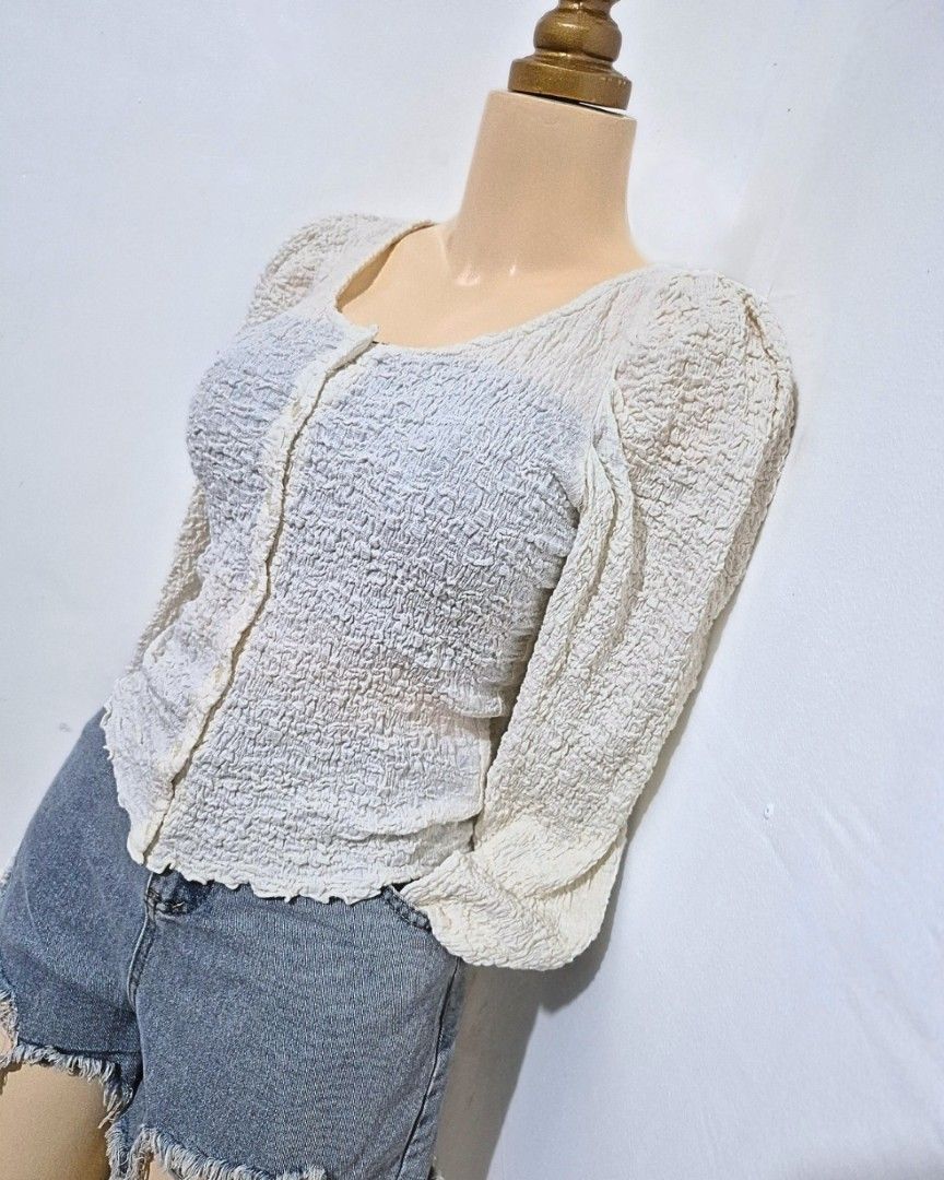 Cream Textured Puff Sleeve Top | S-M (Category: Longsleeves) located in Cabanatuan. Submitted by _erboutique (Listing ID 1466673721, Image 2). Description: • Cream textured top with puff sleeves — so cute & feminine 🤍 • Button front, stretchy smocked fabric, fitted silhouette • Size S–M | Shoulder 13" | Bust 34–36" | Length 21" • Great condition, comfy & easy to wear.