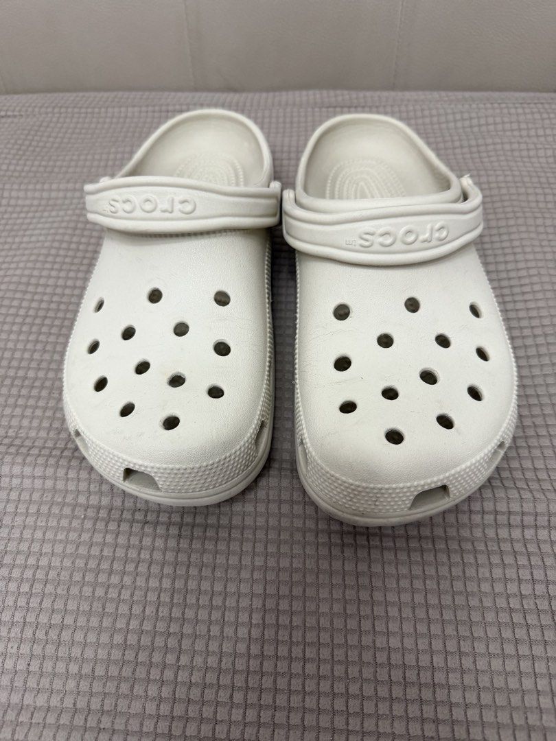 Crocs Classic Clogs Bone (Category: Slippers and slides) located in Quezon City. Submitted by tinamartinez (Listing ID 1466573847, Image 1). Description: - Color: Classic White - Style: Easy slip-on with movable heel strap - Features: Lightweight, breathable ventilation holes, and textured footbed for comfort - Condition: Minimal wear visible, ready to wear.