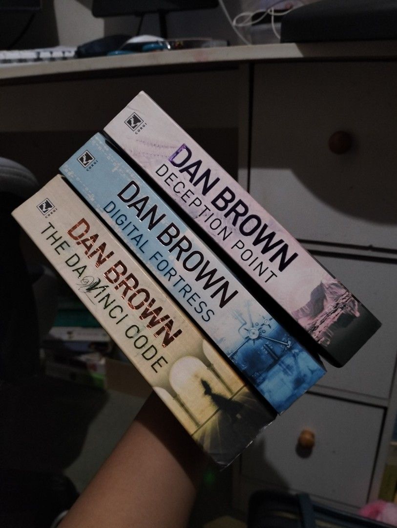 Dan Brown 3 Book Set The Da Vinci Code (Category: Storybooks) located in Batangas. Submitted by maryadims0707_819 (Listing ID 1466743228, Image 1). Description: - Title: Dan Brown Paperback Set of 3 (The Da Vinci Code, Digital Fortress, Deception Point) - Publisher: Corgi - Condition: Pages are complete and intact; Da vinci code has slight reading creases on the spines. the rest of the book has no visible spine crease. TAKE ALL FOR 220.