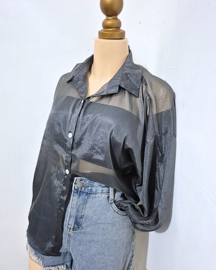 Dark Gray Sheer Shimmer Button-Down Top | L–XL (Category: Longsleeves) located in Cabanatuan. Submitted by _erboutique (Listing ID 1466673288, Image 2). Description: • Dark gray sheer top with subtle shimmer ✨️ • Collared, button-down, relaxed oversized fit • Lightweight & flowy — perfect layered or worn alone • Size L–XL | Shoulder 26½" | Bust 46" | Length 25" • Great condition, ready to wear!.
