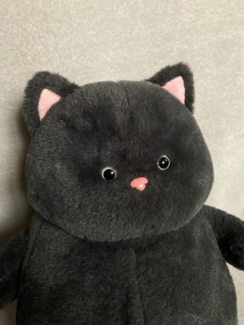 Dark Grey Cat Plush Toy Soft Stuffed Animal (Category: Plushies & Soft Toys) located in Rizal. Submitted by sheeraay (Listing ID 1466647622, Image 2). Description: - Super soft, fluffy black fur - Cute round body with short stubby arms and legs - Detailed with pink inner ears, pink plastic nose, and black button eyes - Features a long tail at the back - Clean and ready for a new home - Perfect cuddle buddy for kids and cat lovers.