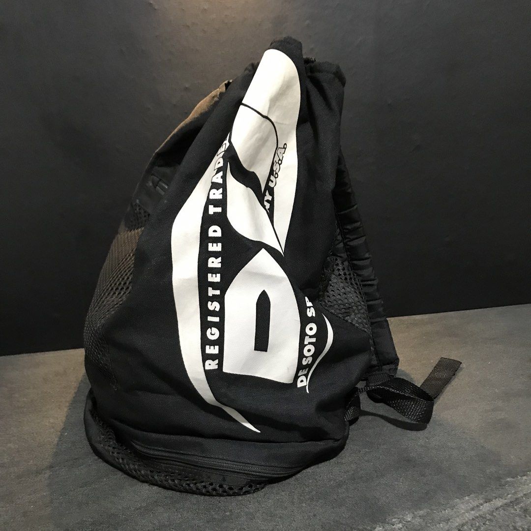 De Soto Sport Company Drawstring Backpack Black (Category: Backpacks) located in Baao. Submitted by all.things.japan (Listing ID 1466712824, Image 2). Description: 17.0 x 11.0 x 14.0 inches - Brand/Model: De Soto Sport Company drawstring backpack - Color: Black with a big white logo on the side - Storage: Main compartment, front zippered pocket, front mesh pouch, and extra bottom compartment - Comfort & Breathability: Adjustable shoulder straps a