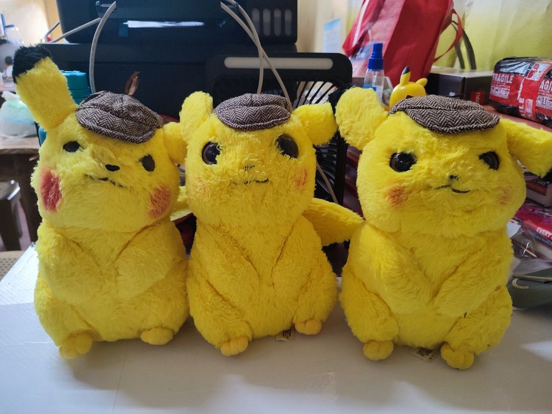 Detective Pikachu Plush Toy Pokémon (Category: Plushies & Soft Toys) located in Manila. Submitted by shop_eyy (Listing ID 1466768215, Image 1). Description: - 150 each po. if take all 400 na lang po. -Official Pokémon Detective Pikachu plush figure - Features iconic brown houndstooth detective hat - Vibrant yellow furry body with red cheeks and black-tipped ears - Made with soft, huggable textured material in a cute sitting posture - Official tag
