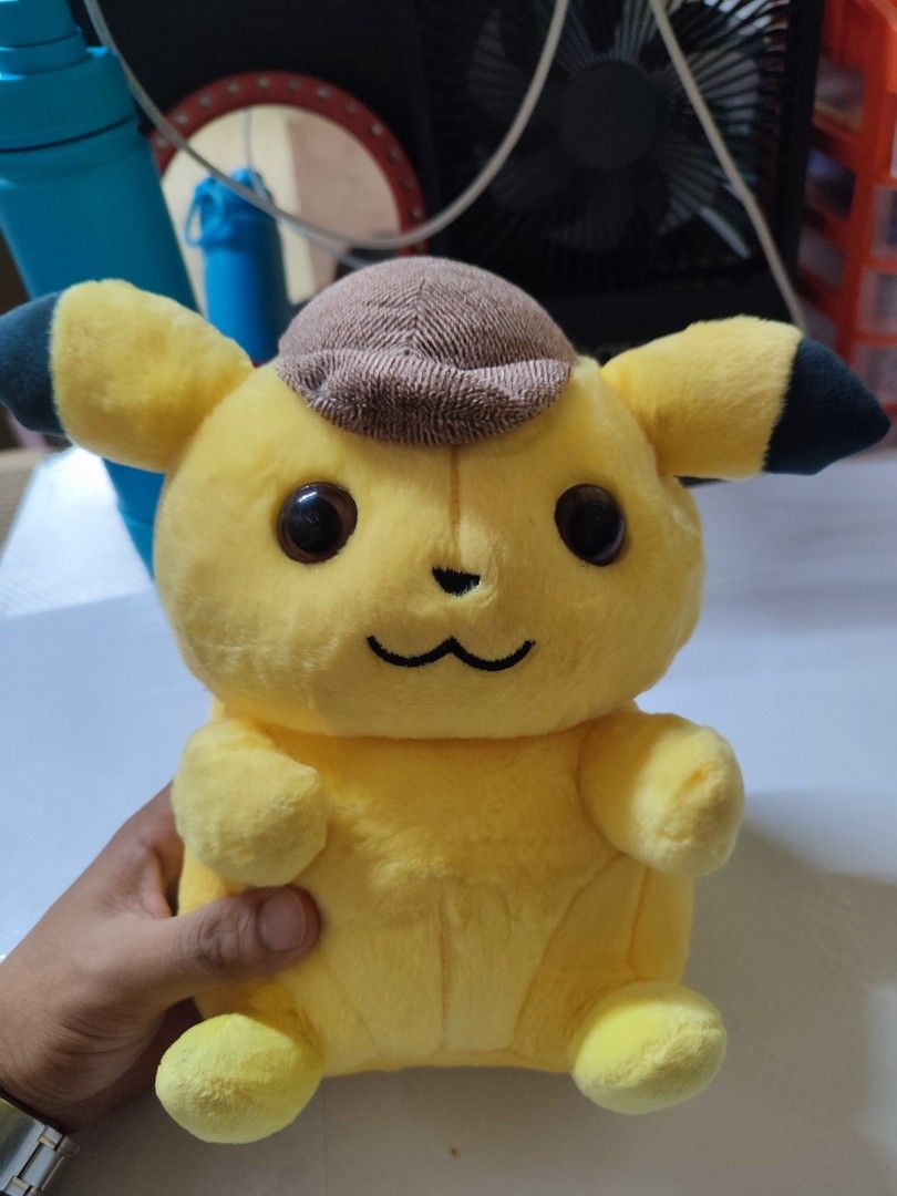 Detective Pikachu Plush Toy with Brown Hat (Category: Plushies & Soft Toys) located in Manila. Submitted by shop_eyy (Listing ID 1466768231, Image 1). Description: - Adorable Detective Pikachu plush wearing a signature brown hat - Soft, fluffy fabric with embroidered smile and round black eyes - Great size for hugging or shelf display - Perfect addition to your room setup or collection -no brand.