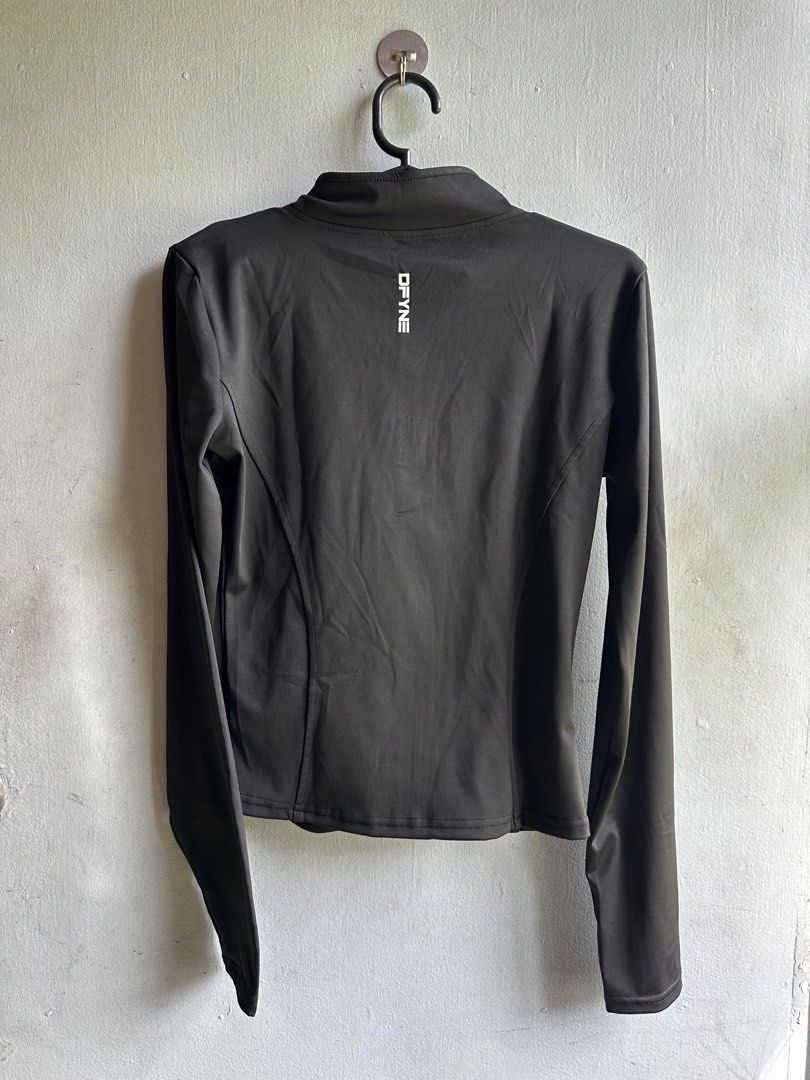 DFYNE Black Athletic Full-Zip Jacket (Category: Coats, Jackets and Outerwear) located in Angeles City. Submitted by alejeong27 (Listing ID 1466571757, Image 2). Description: - Brand: DFYNE - Style: Athletic full-zip jacket with a mock neck and long sleeves - Color: Black with white logo print on the upper left chest and back collar - Fit: Flattering contoured panel seam lines along the front and back - Condition: Brand new in original ziplock pac