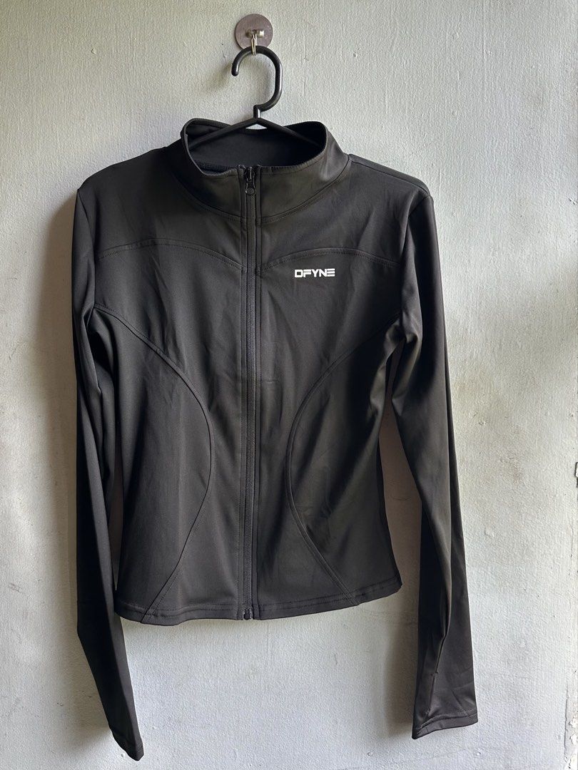 DFYNE Black Athletic Full-Zip Jacket (Category: Coats, Jackets and Outerwear) located in Angeles City. Submitted by alejeong27 (Listing ID 1466571757, Image 1). Description: - Brand: DFYNE - Style: Athletic full-zip jacket with a mock neck and long sleeves - Color: Black with white logo print on the upper left chest and back collar - Fit: Flattering contoured panel seam lines along the front and back - Condition: Brand new in original ziplock pac