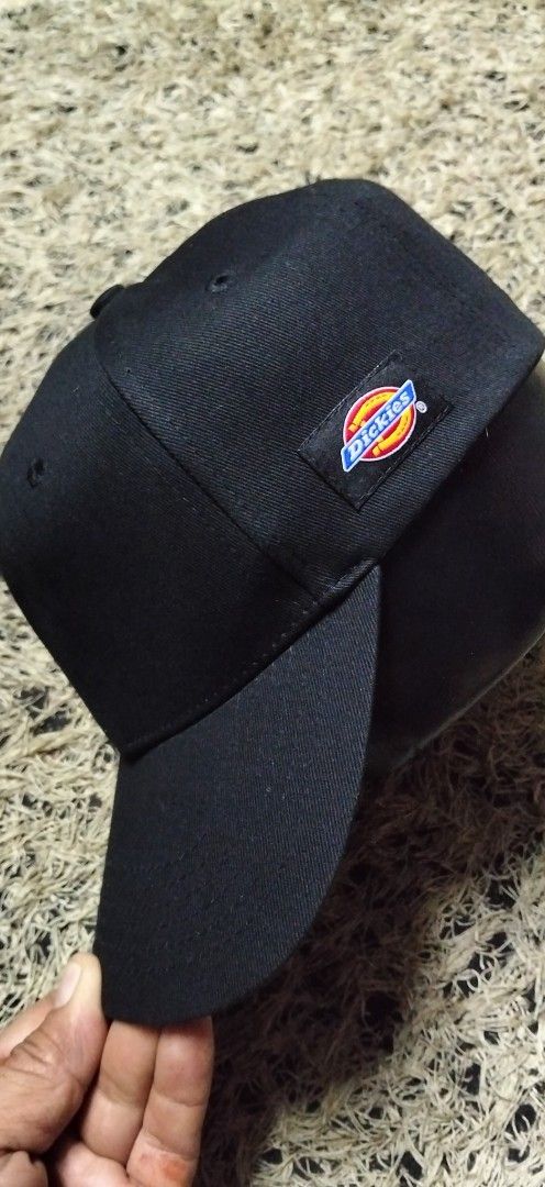 Dickies Black Baseball Cap (Category: Caps & Hats) located in Paranaque City. Submitted by michael-08 (Listing ID 1466756527, Image 1). Description: - Brand: Dickies - Color: Classic black - Design: Embroidered logo patch on the side - Fit: Adjustable strap back closure with metal hardware - Details: Clean panels with stitched eyelets and a curved brim - Condition: Excellent / Brand new DICKIES AUTHENTIC LEGIT ..WALA PO ISSUE LIKE A NEW CONDITION