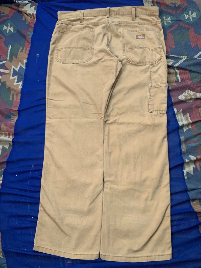 Dickies Men's Canvas Cargo Work Pants Khaki (Category: Trousers) located in Manila. Submitted by gooditem420_forest (Listing ID 1466632949, Image 2). Description: - Brand: Dickies - Color: Khaki Brown - Material: Heavy-duty canvas for long-lasting durability - Fit: Relaxed through seat and thigh with standard waist and belt loops - Features: Multiple utility pockets and side hammer loop - Closure: Standard button closure with zip fly - Condition: