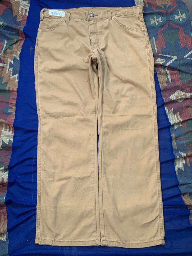 Dickies Men's Canvas Cargo Work Pants Khaki (Category: Trousers) located in Manila. Submitted by gooditem420_forest (Listing ID 1466632949, Image 1). Description: - Brand: Dickies - Color: Khaki Brown - Material: Heavy-duty canvas for long-lasting durability - Fit: Relaxed through seat and thigh with standard waist and belt loops - Features: Multiple utility pockets and side hammer loop - Closure: Standard button closure with zip fly - Condition: