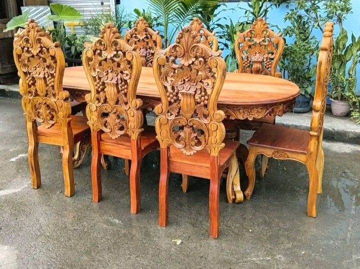 Dining table set (Category: Tables & Sets) located in Manila. Submitted by carmelites36250 (Listing ID 1466612127, Image 2). Description: 8 - seater solid Narra wood Dining Set featuring heavy back-to-back ornate floral and fruit carvings on the chairs and a matching rectangular table. Restored and revarnished. Ready to use. Get it for only P40,000. Size Table L84 x W36 x H32 Chairs L17 x W16 x SH18 x H48 all in inches.