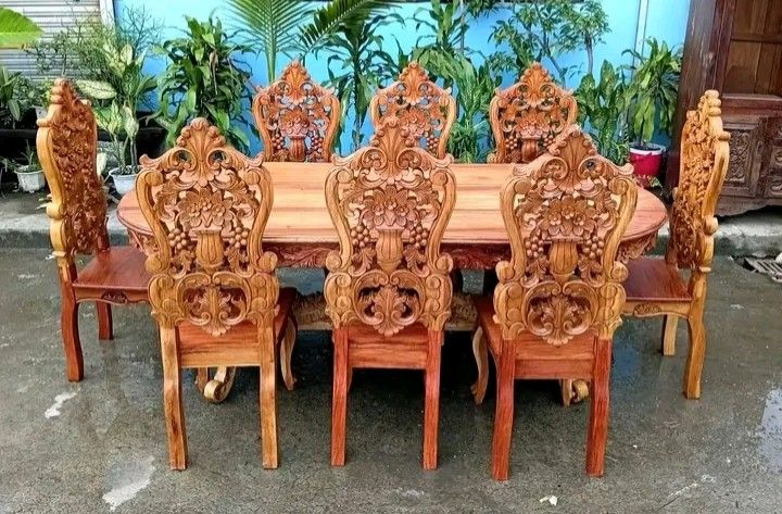 Dining table set (Category: Tables & Sets) located in Manila. Submitted by carmelites36250 (Listing ID 1466612127, Image 1). Description: 8 - seater solid Narra wood Dining Set featuring heavy back-to-back ornate floral and fruit carvings on the chairs and a matching rectangular table. Restored and revarnished. Ready to use. Get it for only P40,000. Size Table L84 x W36 x H32 Chairs L17 x W16 x SH18 x H48 all in inches.
