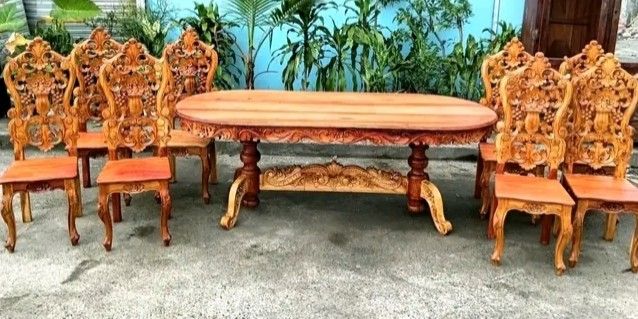Dining table set (Category: Tables & Sets) located in Manila. Submitted by carmelites36250 (Listing ID 1466612127, Image 3). Description: 8 - seater solid Narra wood Dining Set featuring heavy back-to-back ornate floral and fruit carvings on the chairs and a matching rectangular table. Restored and revarnished. Ready to use. Get it for only P40,000. Size Table L84 x W36 x H32 Chairs L17 x W16 x SH18 x H48 all in inches.