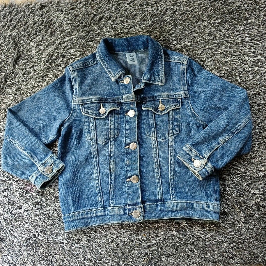 Disney Mickey Mouse Denim Jacket Cat & Jack (Category: Coats, Jackets and Outerwear) located in Kabacan. Submitted by mjhieshandpicked_19 (Listing ID 1466707509, Image 3). Description: - Brand: Cat & Jack - Style: Light wash denim jacket with all-over Mickey Mouse print - Details: Classic button-down front, two chest flap pockets, button cuffs, and branded metal buttons - Special Feature: Red embroidered Mickey Mouse patch on the right chest pock