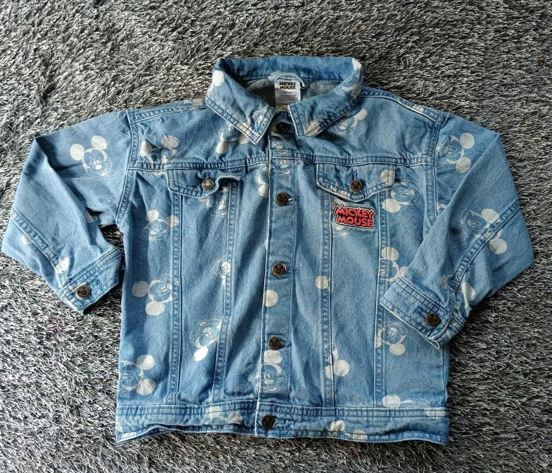 Disney Mickey Mouse Denim Jacket Cat & Jack (Category: Coats, Jackets and Outerwear) located in Kabacan. Submitted by mjhieshandpicked_19 (Listing ID 1466707509, Image 1). Description: - Brand: Cat & Jack - Style: Light wash denim jacket with all-over Mickey Mouse print - Details: Classic button-down front, two chest flap pockets, button cuffs, and branded metal buttons - Special Feature: Red embroidered Mickey Mouse patch on the right chest pock