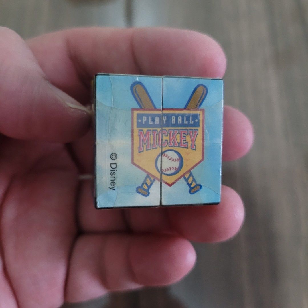 Disney Mickey Mouse Donald Duck baseball puzzle cube (Category: Board Games & Puzzles) located in Pasig City. Submitted by samnok_toys_ph (Listing ID 1466622905, Image 1). Description: - Official Disney licensed mini puzzle cube - Features vibrant Mickey Mouse and Donald Duck baseball artwork on all sides - Compact novelty toy measuring just a few centimeters - Clean surface with crisp, bright printed designs - Includes official holographic Disne
