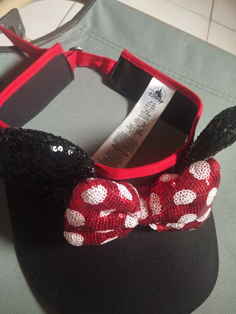 Disney Minnie Mouse Sequin Ears Visor Cap Red Black (Category: Hats & Beanies) located in Manila. Submitted by ljaneee (Listing ID 1466576115, Image 2). Description: - Official Disney Minnie Mouse visor cap - Black brim with sparkly black sequin ears - Iconic red sparkly bow with white polka dots - Adjustable strap at the back with red trim for a custom fit - One size fits most - Brand new with official tag attached.