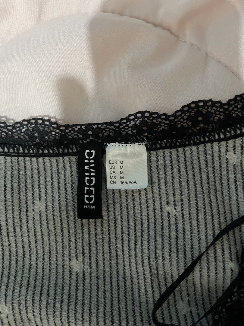 Divided H&M Black Floral Crop Top (Category: Sleeveless) located in Manila. Submitted by voidkar (Listing ID 1466645630, Image 2). Description: Divided by H&M black floral crop top in size M. Features a ribbed knit fabric, V-neckline with black lace trim, and lettuce edge details. Super cute Y2K style..