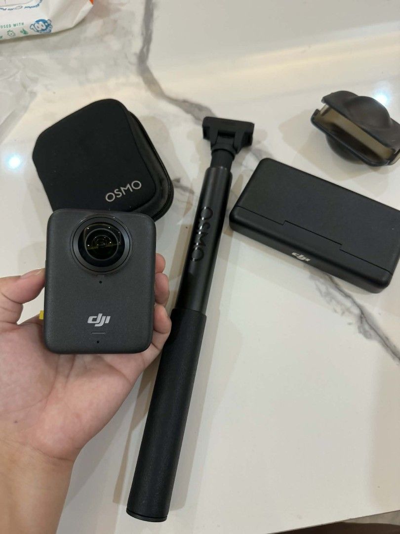 DJI Osmo Action 3 camera bundle with extension rod (Category: Other Gadgets) located in Pasay City. Submitted by pepper1997 (Listing ID 1466653784, Image 2). Description: - Complete DJI Osmo Action camera bundle - Includes main camera unit, extension selfie pole, protective case, lens cover, and battery charging case - Ideal setup for vlogging and outdoor action shots - Clean condition and fully functional - Grab it before it's gone!.