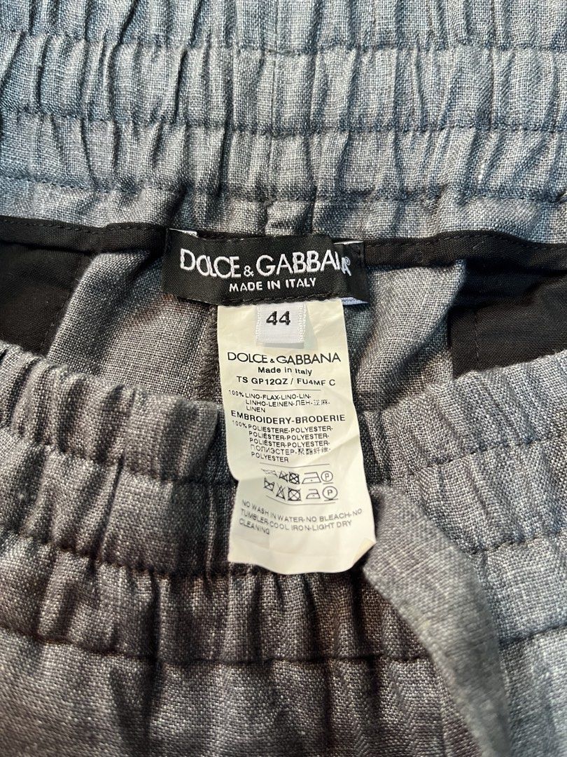 Dolce & Gabbana Grey Linen Drawstring Pants Size 44 (Category: Trousers) located in Dumangas. Submitted by duerocharl67867 (Listing ID 1466567473, Image 2). Description: - Brand: Dolce & Gabbana - Color: Grey - Size: 44 (Tag attached) - Material: 100% Linen (Made in Italy) - Waistband: Elastic with drawstring closure and branded metallic aglets - Pockets: Dual rear welt pockets with button closures - Details: Signature embroidered DG logo on the 
